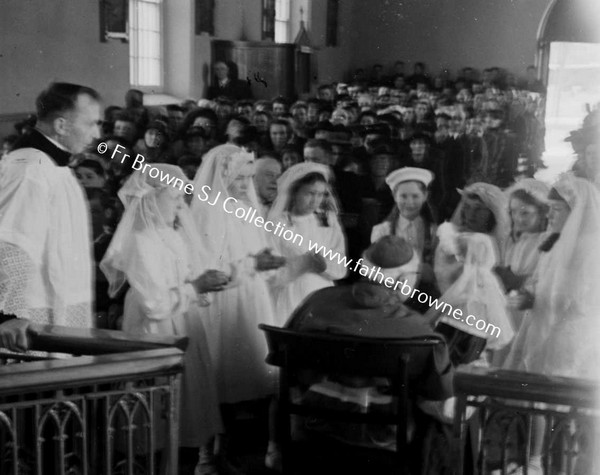 BISHOP EXAMINING CHILDREN